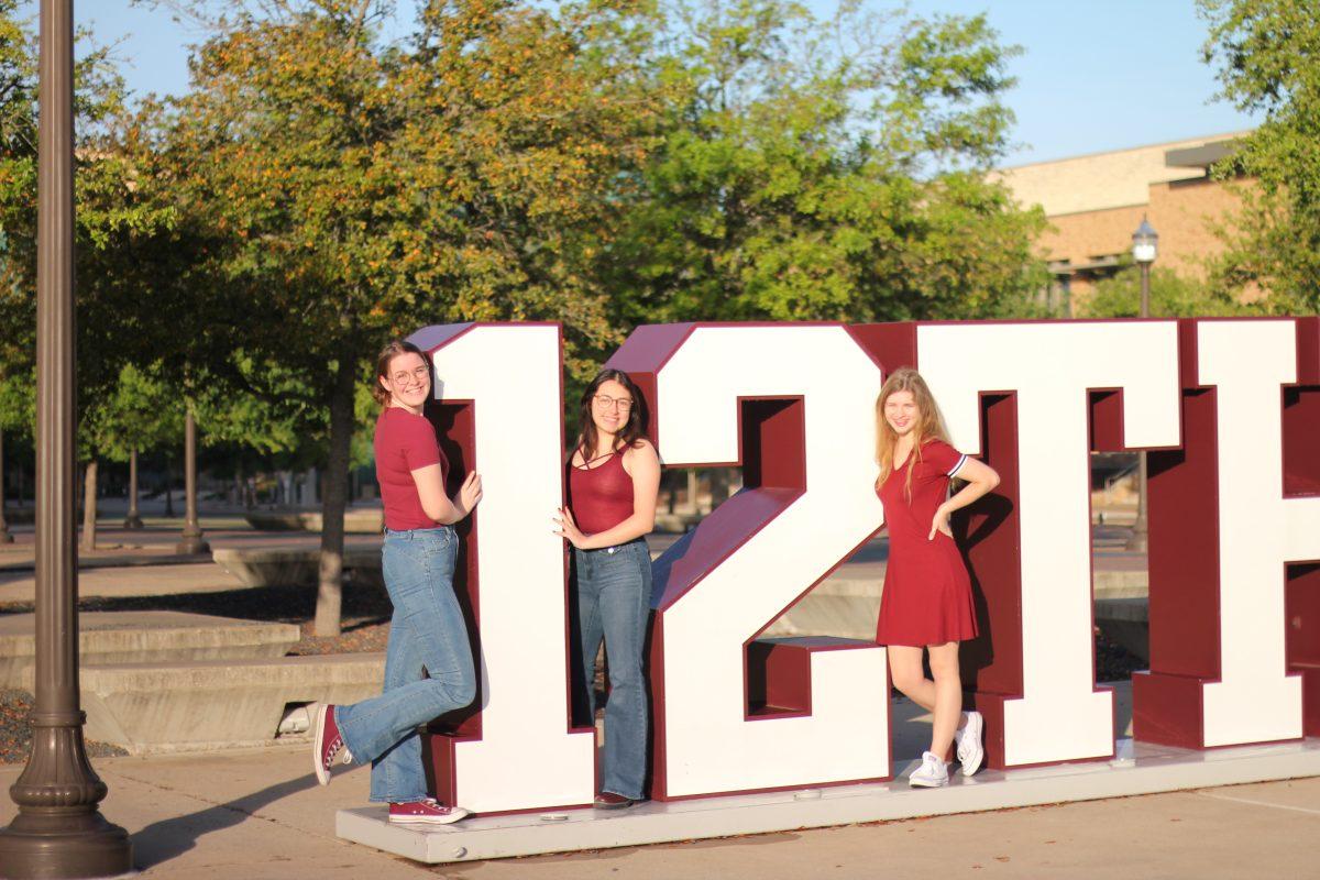 Aggies pose beside the 12th Man sign on Saturday, March 31.