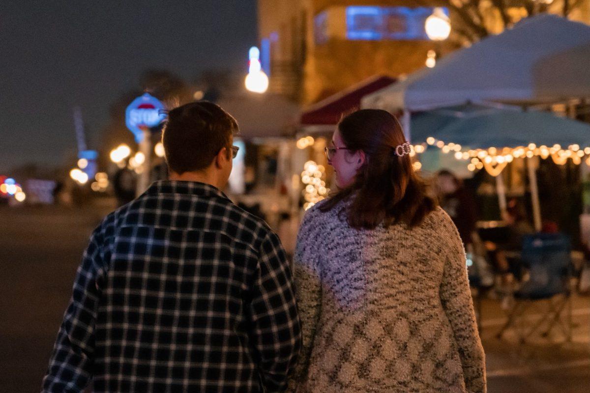 A couple walks on the streets of Downtown Bryan during First Friday on Friday, Dec. 2, 2022.