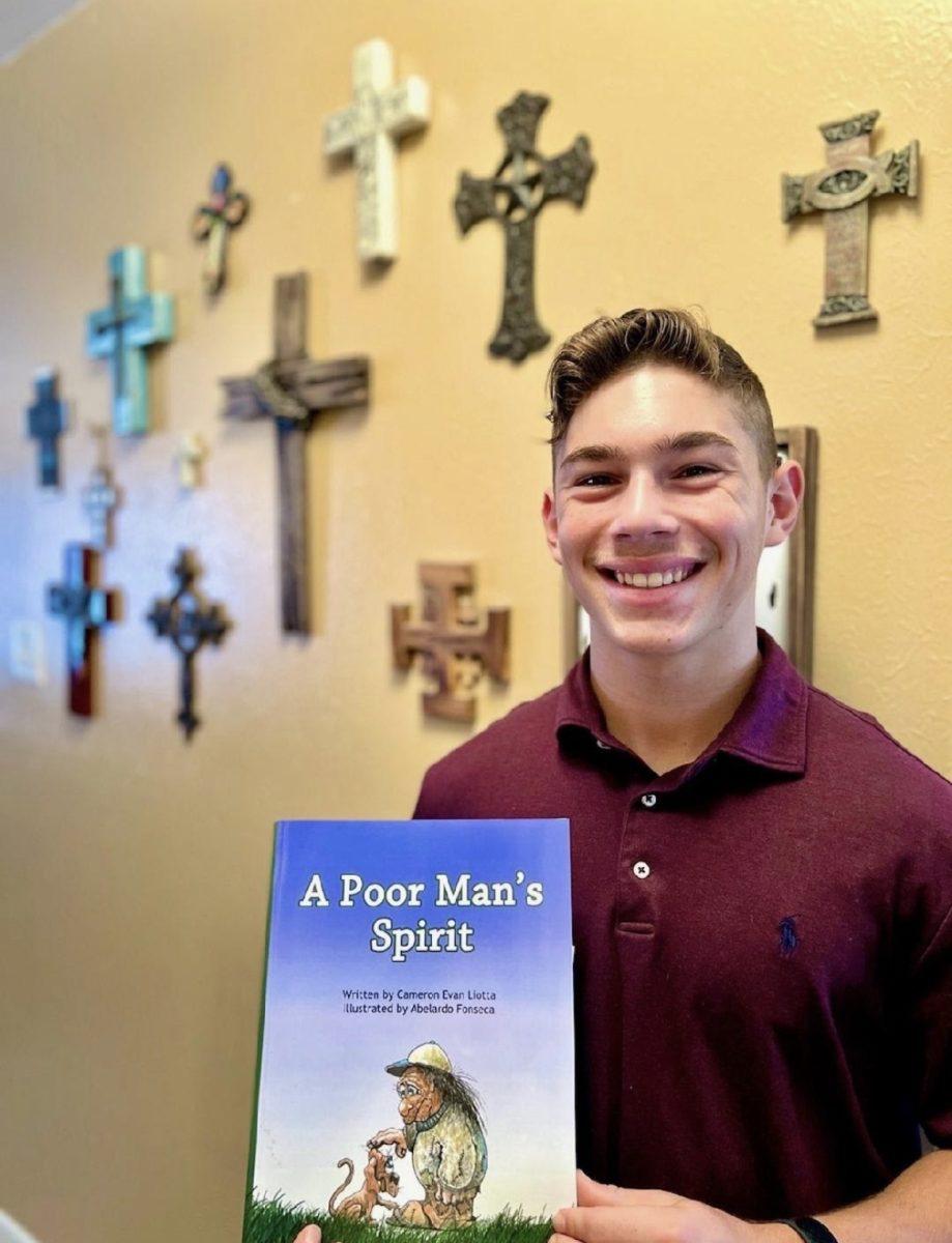 Cameron Liotta holds up his new book, A Poor Mans Spirit. 