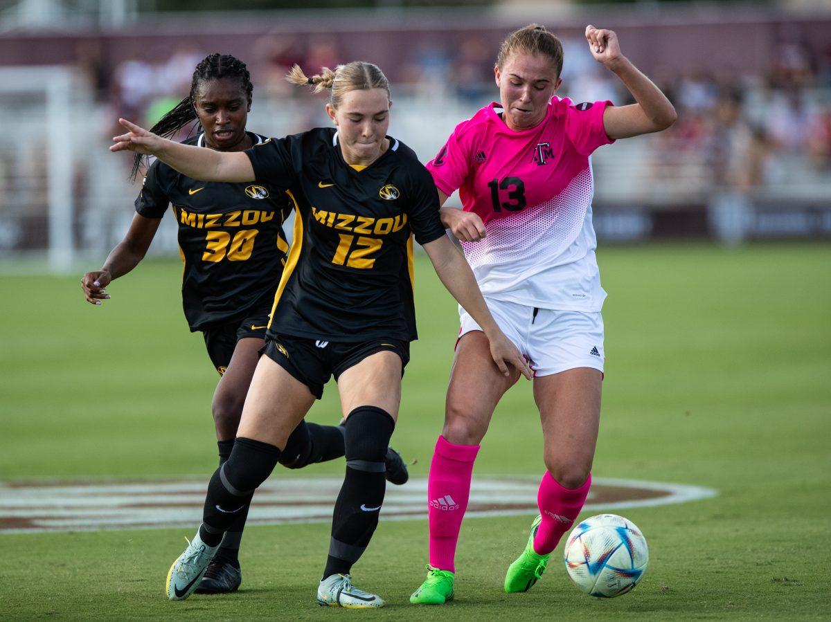 <p>Sophomore D Mia Pante (13) keeps the ball away from Mizzou's Leah Selm (12) during A&M's match against Mizzou at Ellis Field on Sunday, Oct. 23, 2022.</p>