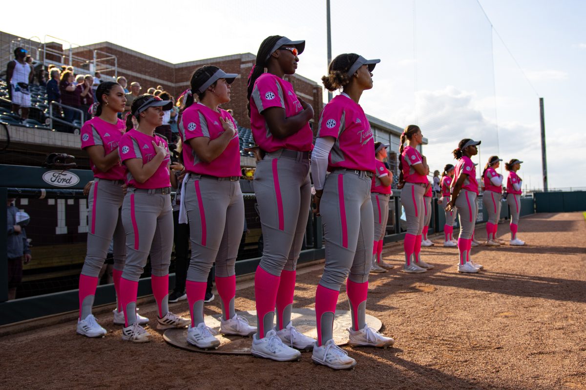 Texas A&amp;M softball players stand for the national anthem during Texas A&amp;M's game against Texas State at Davis Diamond on Wednesday, April 19, 2023.