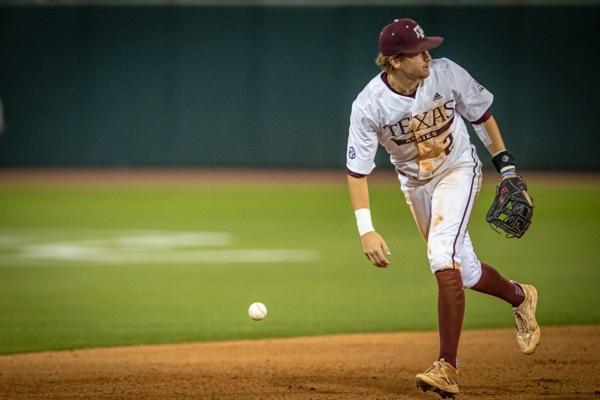 Junior SS Hunter Hass (2) fields a ground ball hit to short during Texas A&Ms game against Texas at Olsen Field on Tuesday, March 28, 2023.