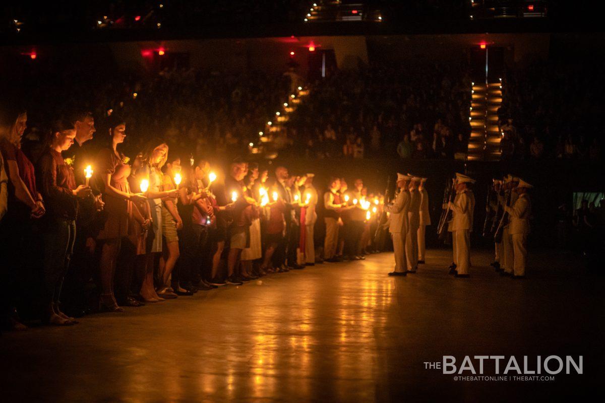 Someone holds a candle during Muster in Reed Arena on Thursday, April 21, 2022.