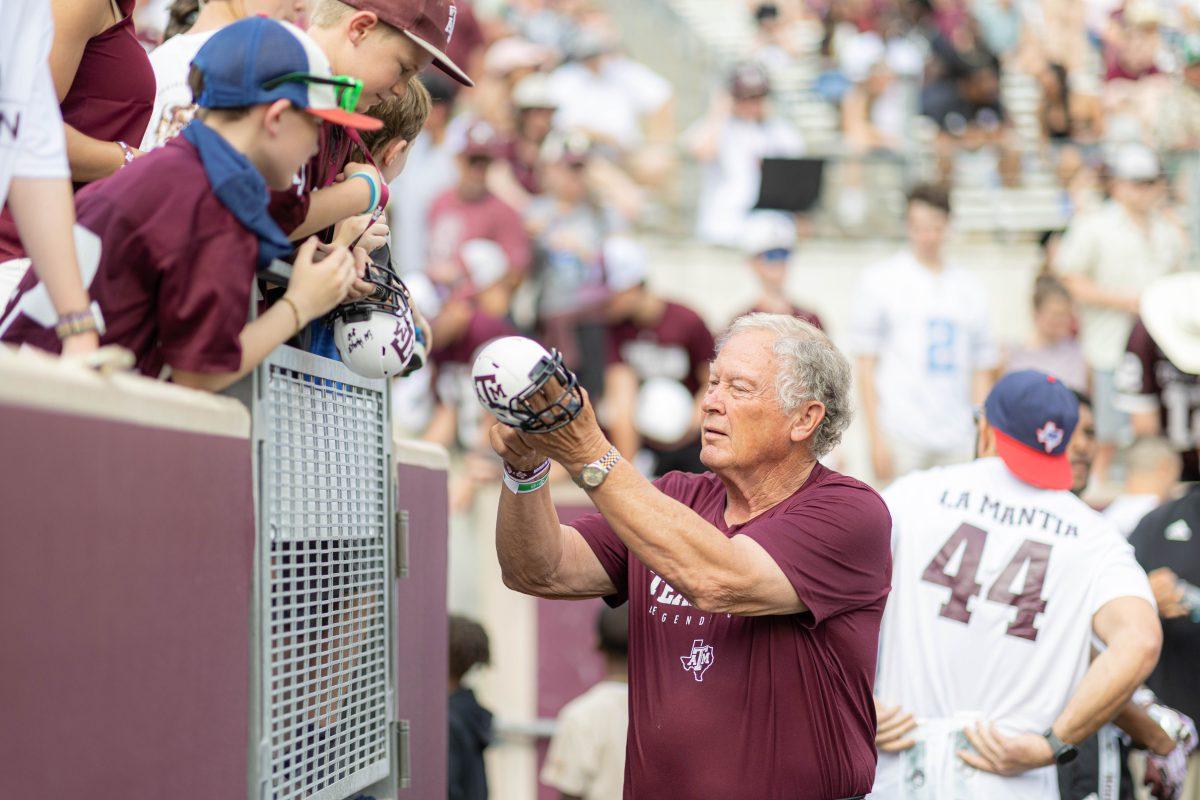 Texas A&M Athletics Hall of Fame member Edd Harget signs a football helmet on Saturday, April 8, 2023 at Kyle Field during the Maroon and White game.