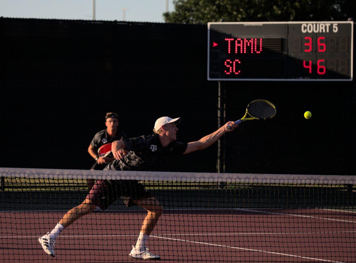 Junior Kenner Taylor (front) reaches for the ball during his doubles match with Junior Raphael Perot (back) against South Carolina at the Mitchell Outdoor Tennis Center on April 13, 2023.