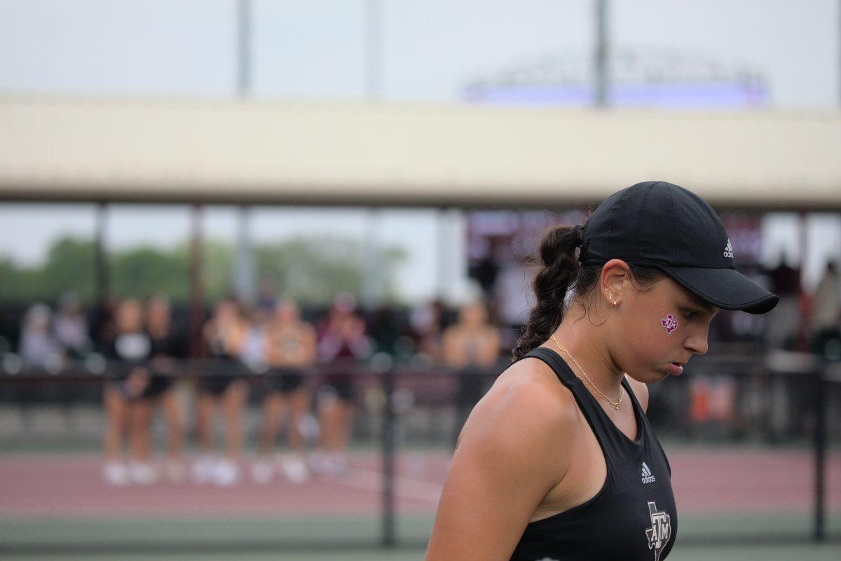 <p>Sophomore Mia Kupres prepares for the next serve as her teammates watch at the Mitchell Outdoor Tennis Center on April 2, 2023.</p>