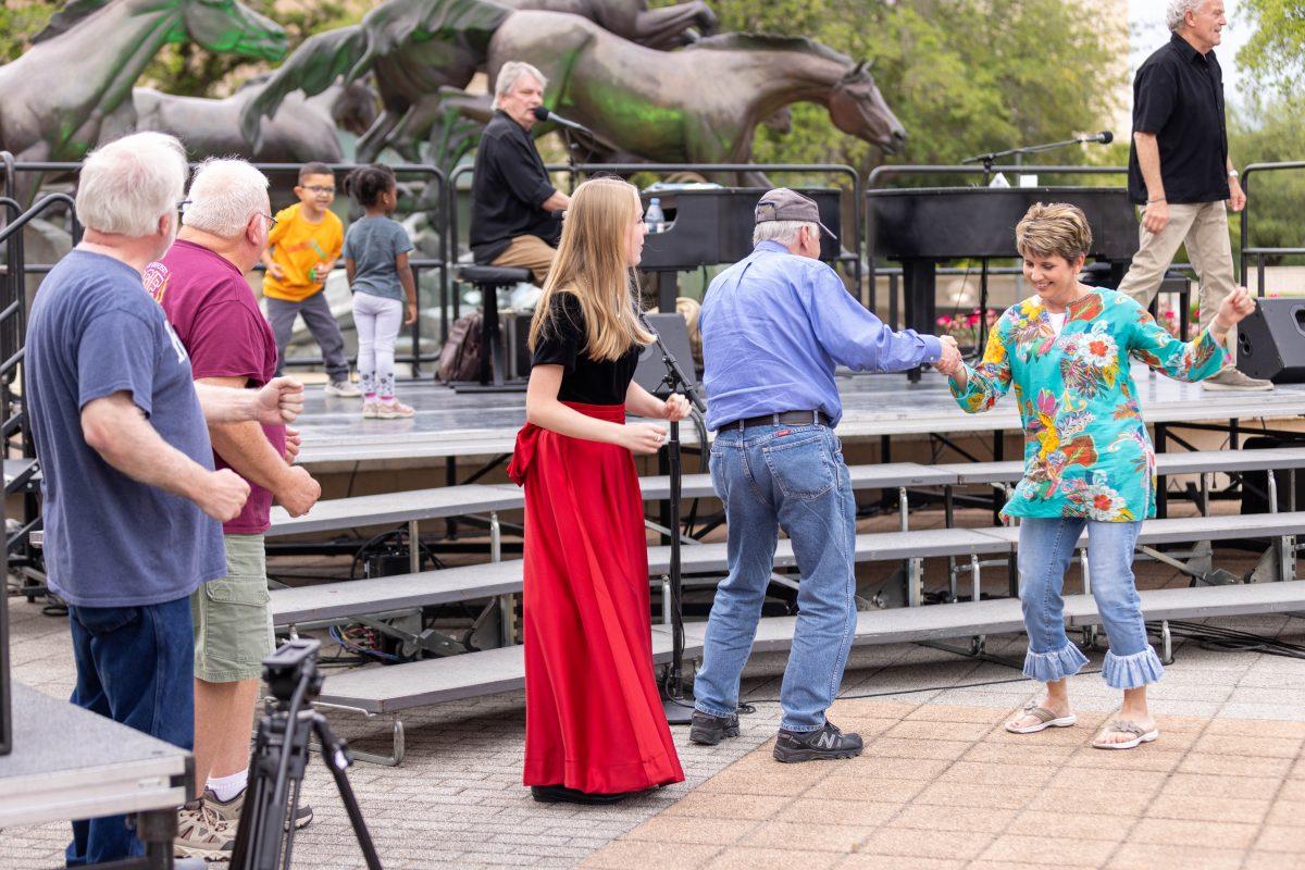 People dance at the Bush Museum amphitheater during its 25th anniversary on Saturday, April 22, 2023. 