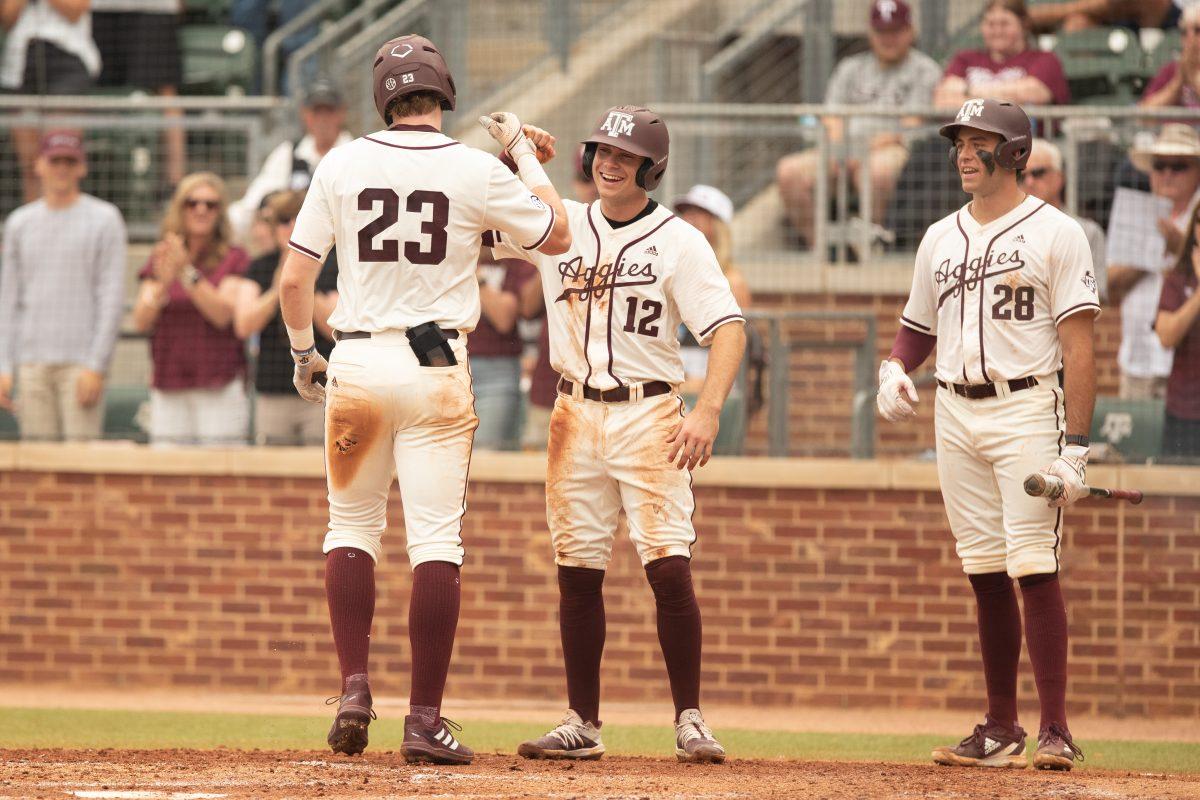 Senior OF Brett Minnich (23) celebrates with Senior INF Austin Bost (12) and Junioe INF Trevor Werner (28) after hitting a home run during Texas A&Ms game against Ole Miss at Olsen Field on Sunday, April 2, 2023.