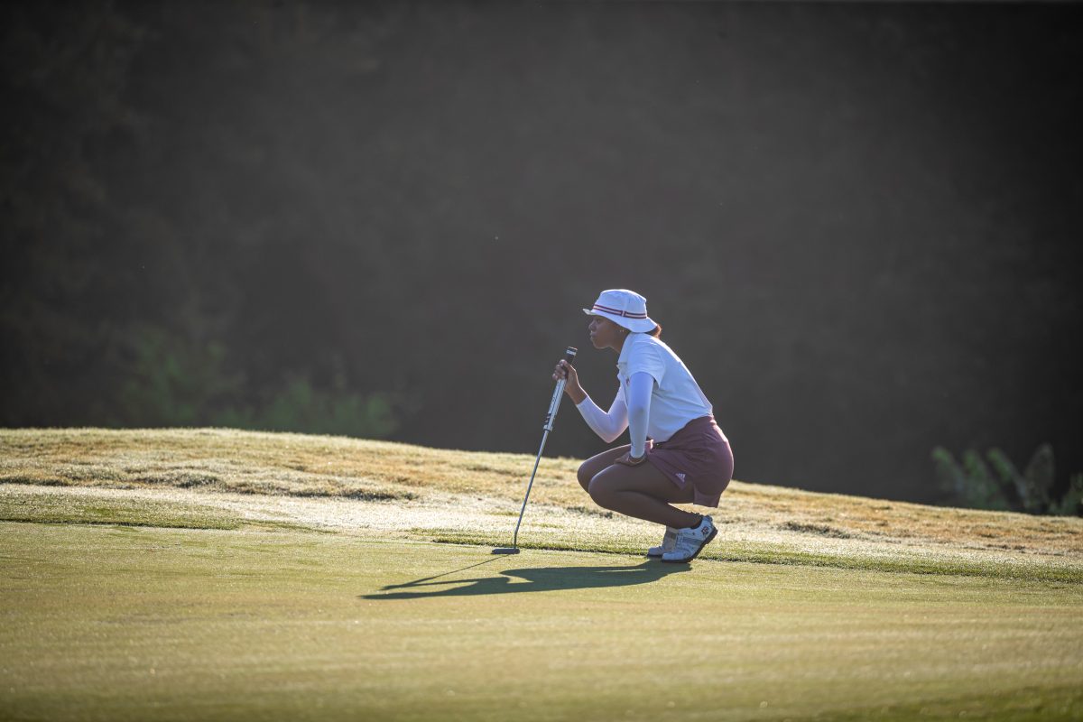 <p>Junior Zoe Slaughter lines up her putt on the green the 2nd hole of the Traditions Club on the second day of the 