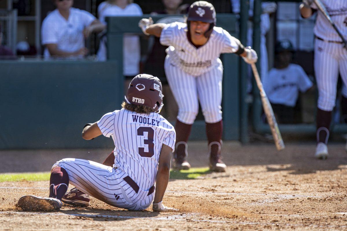 Sophomore INF Koko Wooley (3) looks back at her teammate after stealing home base during Texas A&Ms game against Mizzou at Davis Diamond on Sunday, April 30, 2023.