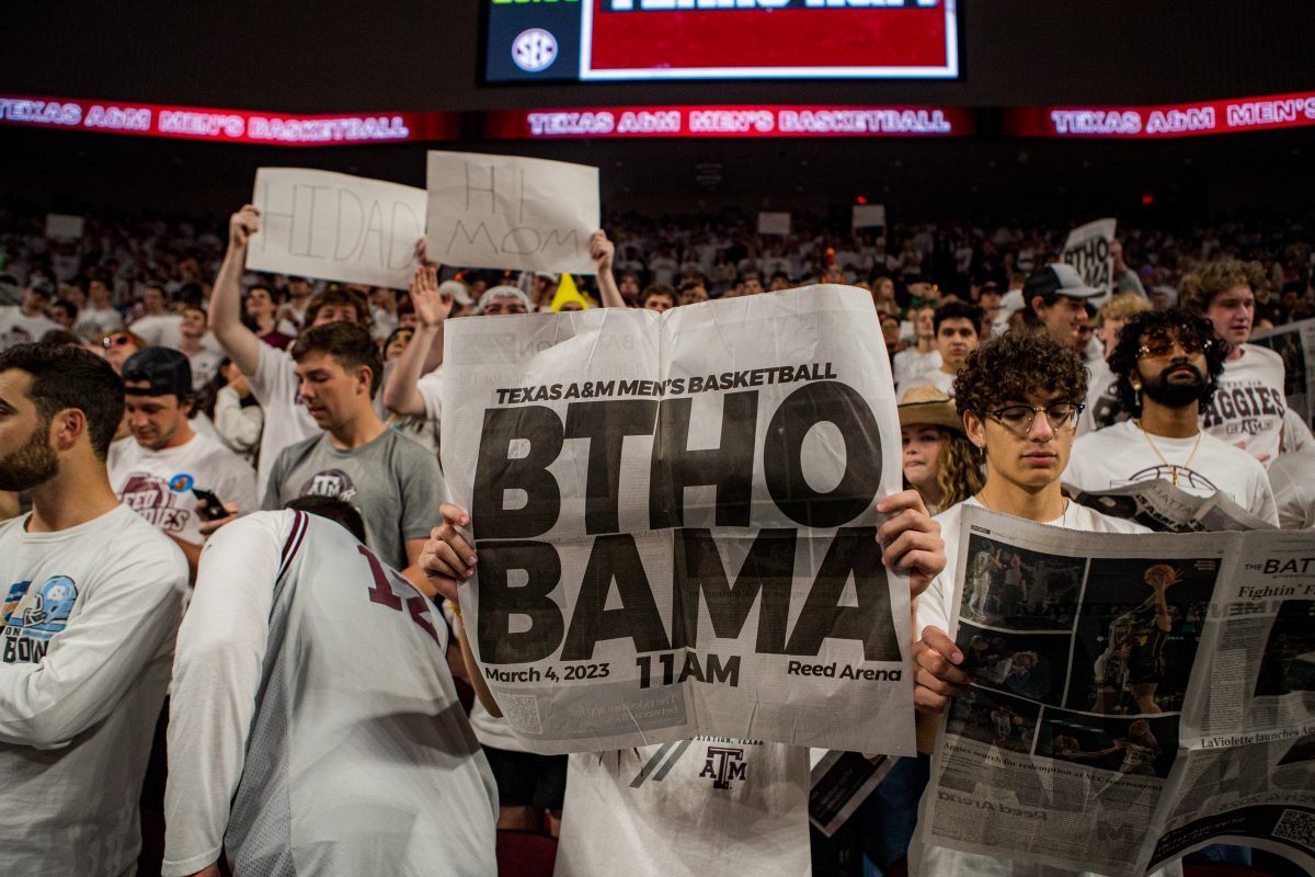 Students hold up newspapers while Alabama's roster is being called on Saturday, March 4, 2023.