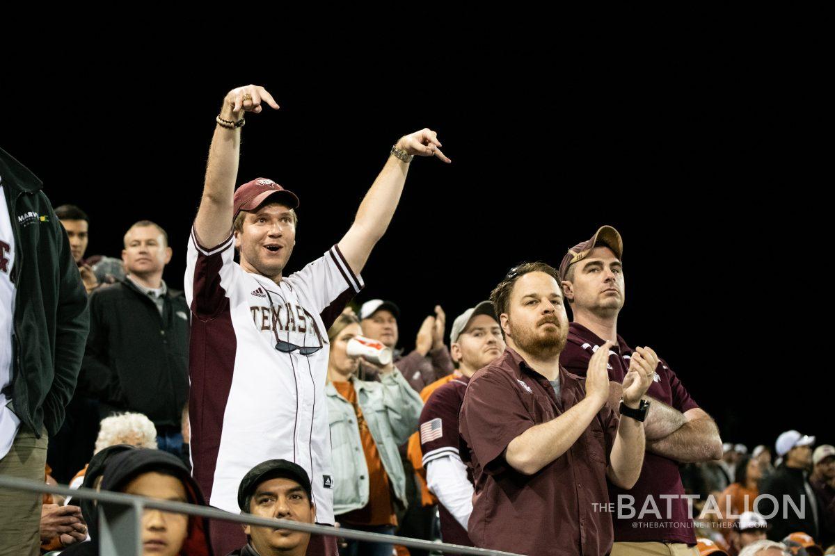 An+Aggie+throws+the+horns+down+hand+sign+during+a+baseball+game+against+the+University+of+Texas+at+Disch-Falk+Field+in+Austin+in+2019.