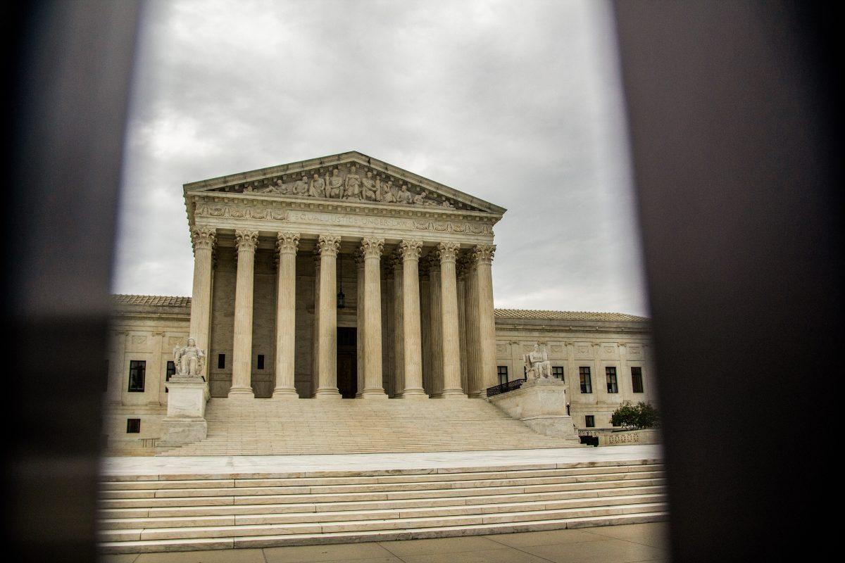 The Supreme Court as seen through a perimeter fence on July 26, 2022. (Cameron Johnson/The Battalion)