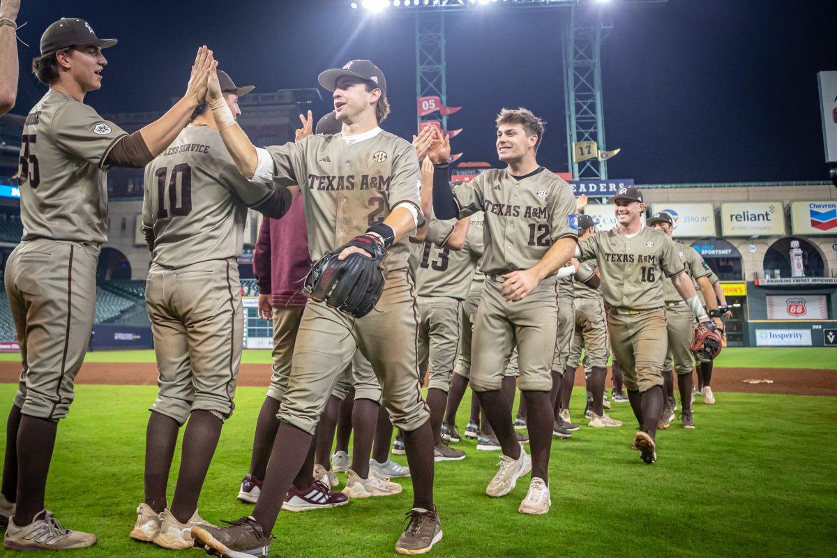 The Aggies celebrate after Texas A&M won its game against Texas Tech at Minute Maid Park in Houston, Texas, on Monday, March 6, 2023.
