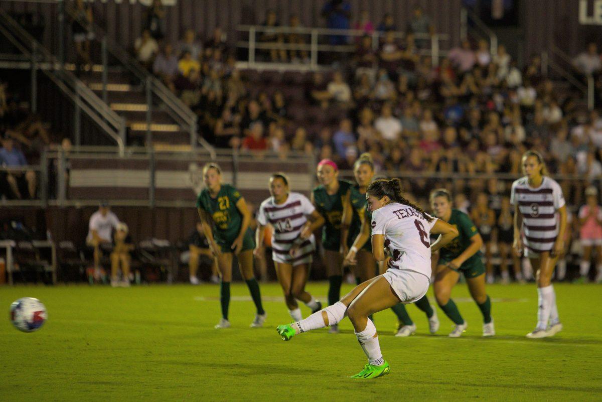 Junior Forward Maile Hayes (8) shoots the penalty kick that ties the game at the Aggies match against Baylor at Ellis Field on Saturday, Aug. 26, 2023.