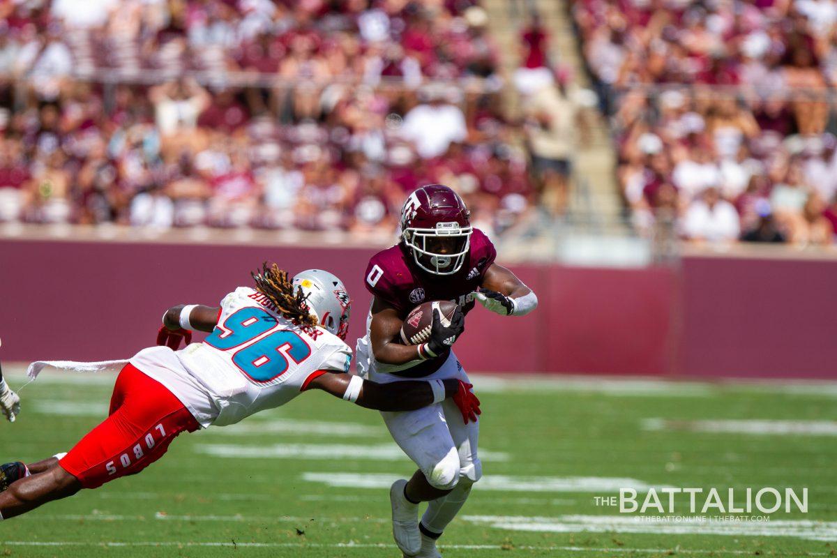 Ainias Smith breaks through an attempted tackle by Corey Hightower.