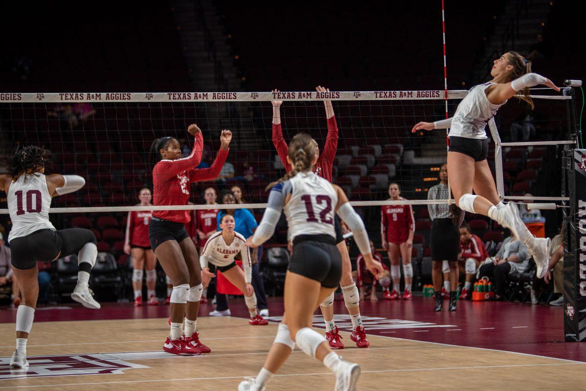 Freshman OPP Logan Lednicky (9) spikes the ball during A&Ms match against Alabama at Reed Arena on Wednesday, Nov. 2, 2022.