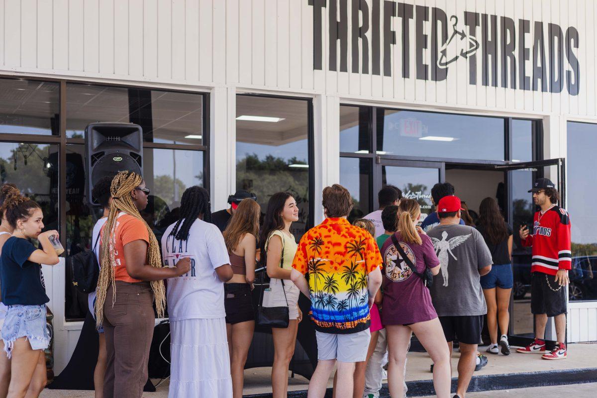 Owner Laith Awad welcomes guest to the Thrifted Threads grand opening in College Station, Texas on Saturday, Aug. 26, 2023. 