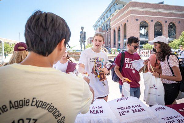 Texas A&M staff distribute 12th Man towels to students during the Ice Cream Carnival as part of the Howdy Week Festivities at the 12th Man Plaza on Friday, Aug. 18, 2023.