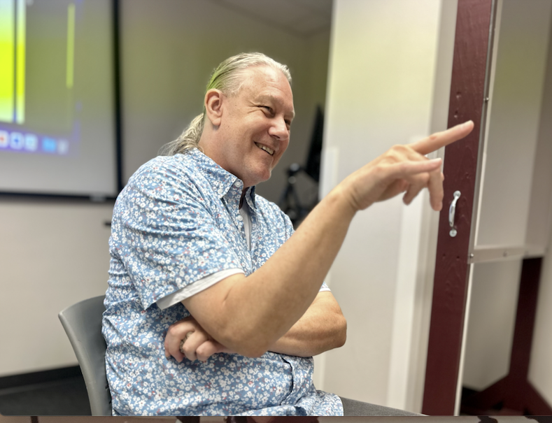 Texas A&M communication and journalism professor Larry Lemmons smiling as he energetically instructs his JOUR 203 Media Writing I class in Bolton Hall on Sept. 8, 2023. 
 