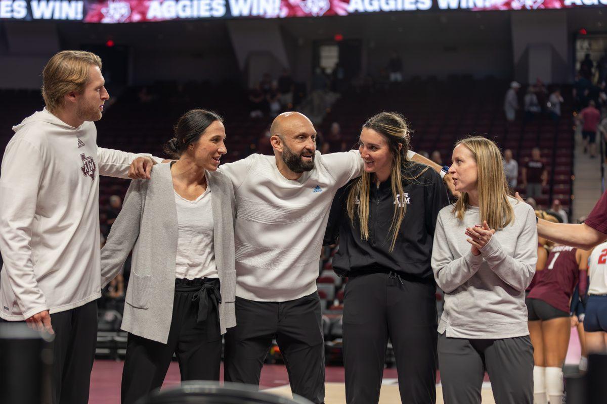 Associate Head Coach Lindsey Walton, Head Coach Jamie Morrison, and the volleyball staff line up for the Aggie War Hymn during Texas A&Ms game against Liberty on Friday, Sept. 15, 2023 at Reed Arena. (CJ Smith/The Battalion)
