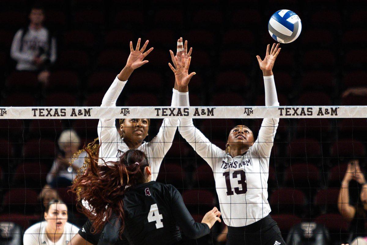 Sophomore MB Morgan Perkins (21) and Freshman OH Bianna Muoneke (13) jump to block the ball during Texas A&Ms game against Mississippi State at Reed Arena on Wednesday, Sept. 20, 2023.