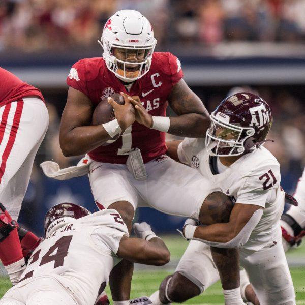 Senior LB Chris Russell Jr. (24) and freshman LB Taurean York (21) sacks QB KJ Jefferson (1) during the Southwest Classic against Arkansas at AT&T Stadium on Saturday, Sept. 30, 2023. (Chris Swann/The Battalion)