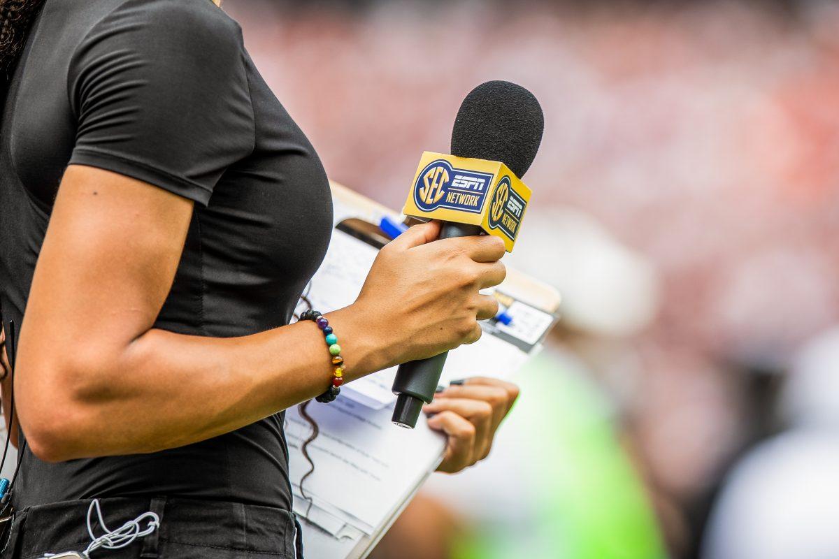 An SEC microphone in the hand of a sideline reporter during the Texas A&amp;M Football vs. Sam Houston game on Saturday, Sept. 3, 2022.