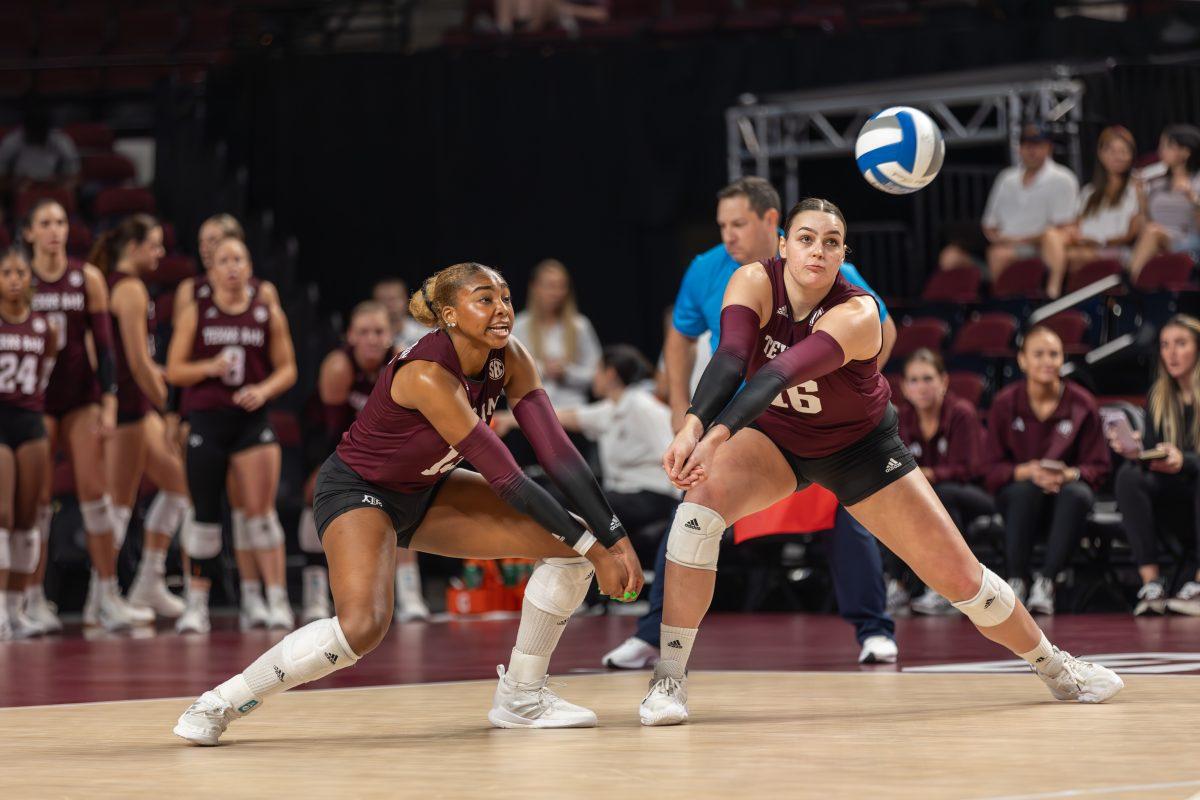 Freshman OH Bianna Muoneke (13) and graduate OH Caroline Meuth (16) go to receive the serve during Texas A&Ms game against Liberty on Friday, Sept. 15, 2023 at Reed Arena. (CJ Smith/The Battalion)