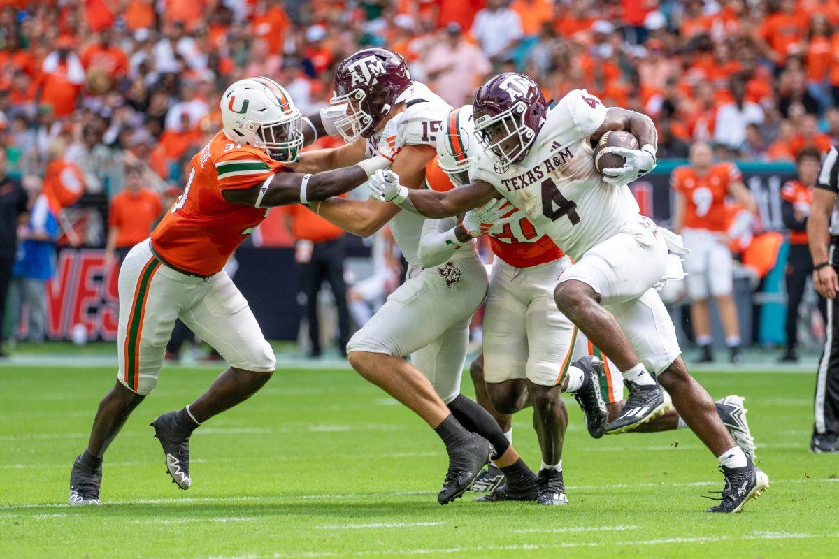 Junior RB Amari Daniels (4) pushes through the defensive line in the first quarter during Texas A&M’s game against Miami on Saturday, Sept. 9, 2023 at Hard Rock Stadium in Miami Gardens, Fla.