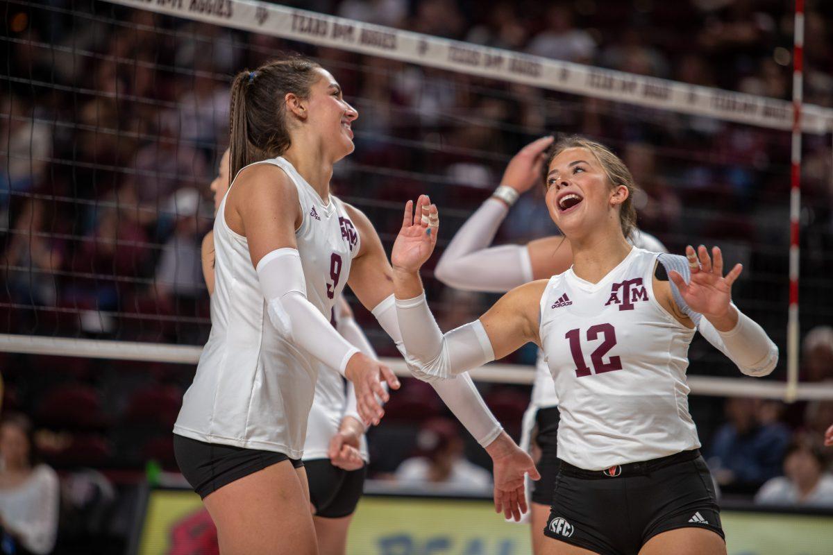Freshman L/DS Ava Underwood (12) and Freshman OPP Logan Lednicky (9) are all smiles after a point during A&Ms match against Alabama at Reed Arena on Wednesday, Nov. 2, 2022.