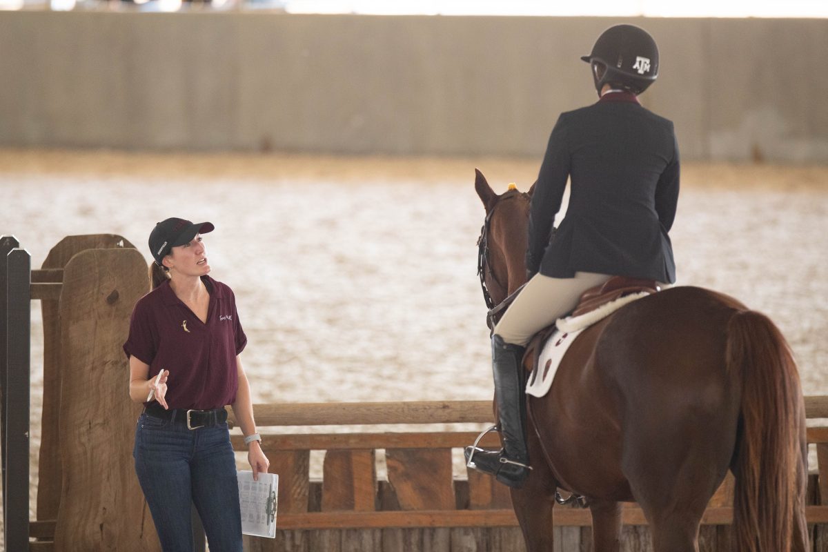 Associate Head Coach Abby O'Mara gives advice to a jumping seat rider during warmups at the Texas A&amp;M vs Baylor Equestiran Meet on Sept. 29, 2023 at Hildbrand Equine Complex. (Julianne Shivers/ The Battalion)