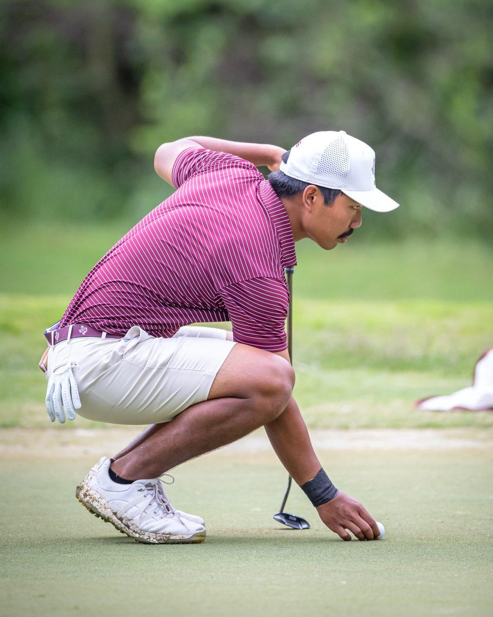 Sophomore+Phichaksn+Maichon+looks+over+a+putt+on+the+third+hole+of+the+Traditions+Club+on+the+second+day+of+the+Aggie+Invitational+on+Tuesday%2C+April+11%2C+2023.