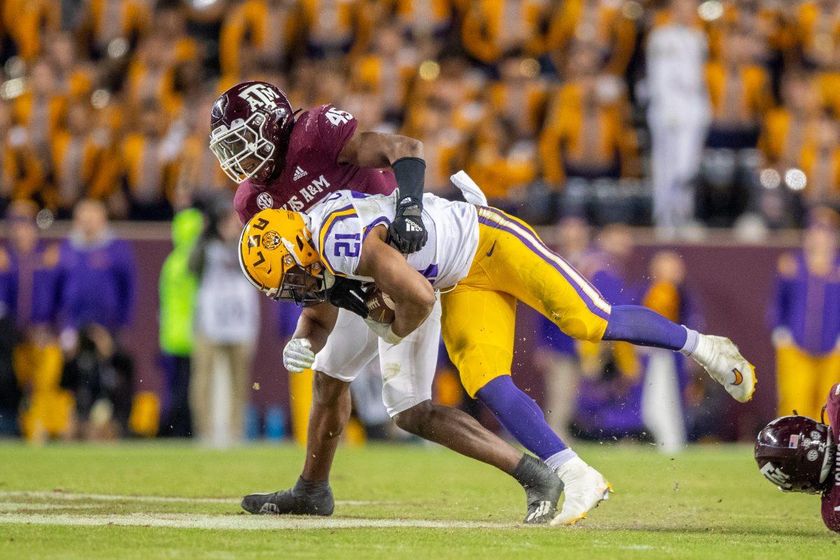 <p>Sophomore LB Edgerrin Cooper (45) makes a tackle during A&M's game at Kyle Field on Saturday, Nov. 26, 2022. (Jonathan Taffet/The Battalion)</p>