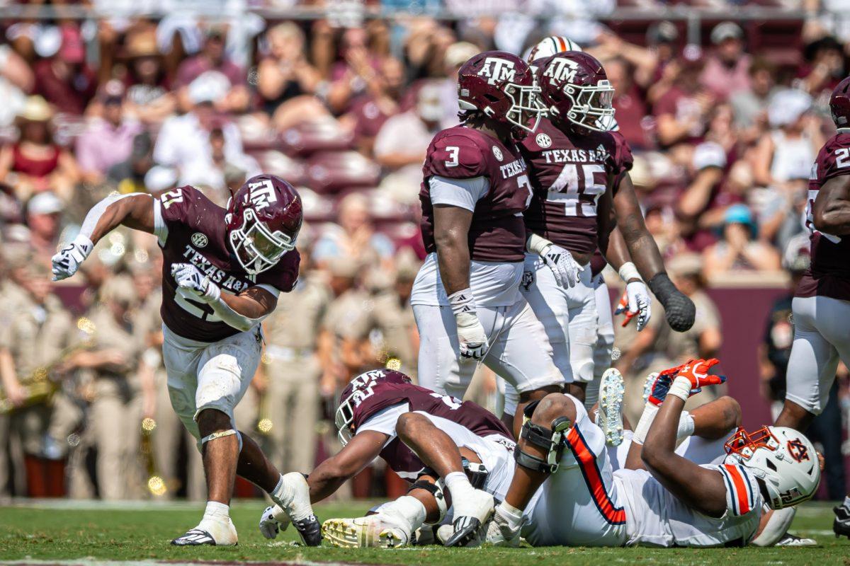 Freshman LB Taurean York (21) celebrates after sophomore DL Shemar Stewart sacked Auburn QB Payton Thorne (1) during Texas A&Ms football game against Auburn at Kyle Field on Saturday, Sept. 23, 2023.