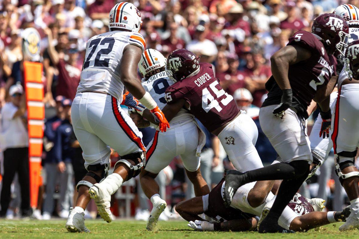 Junior LB Edgerrin Cooper (45) tackles Auburn QB Robby Ashford (9) for a loss of yards during Texas A&Ms game against Auburn on Saturday, Sept. 23, 2023 at Kyle Field. (CJ Smith/The Battalion)