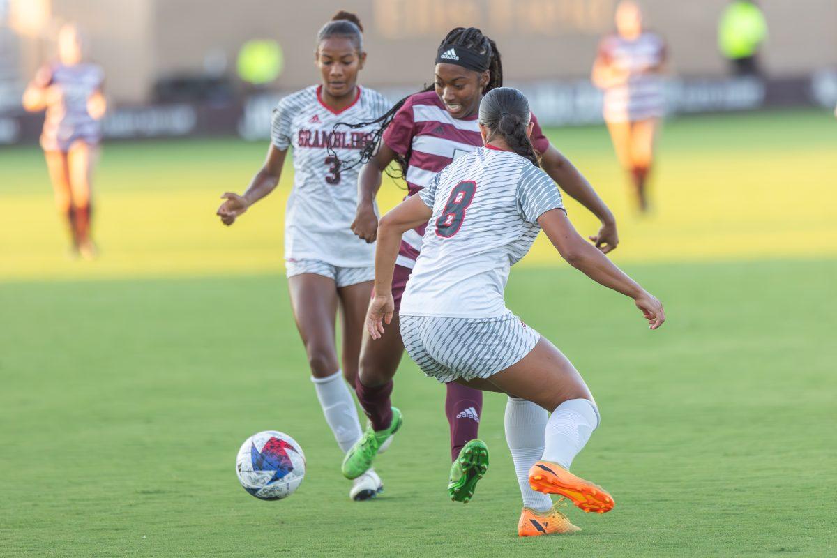 <p>Junior F MaKhiya McDonald (5) crosses between during Grambling State F Aria Whitney (3) and F Karlyn Judge (8) during Texas A&M's game against Grambling State on Thursday, Sept. 7, 2023 at Ellis Field. (CJ Smith/The Battalion)</p>