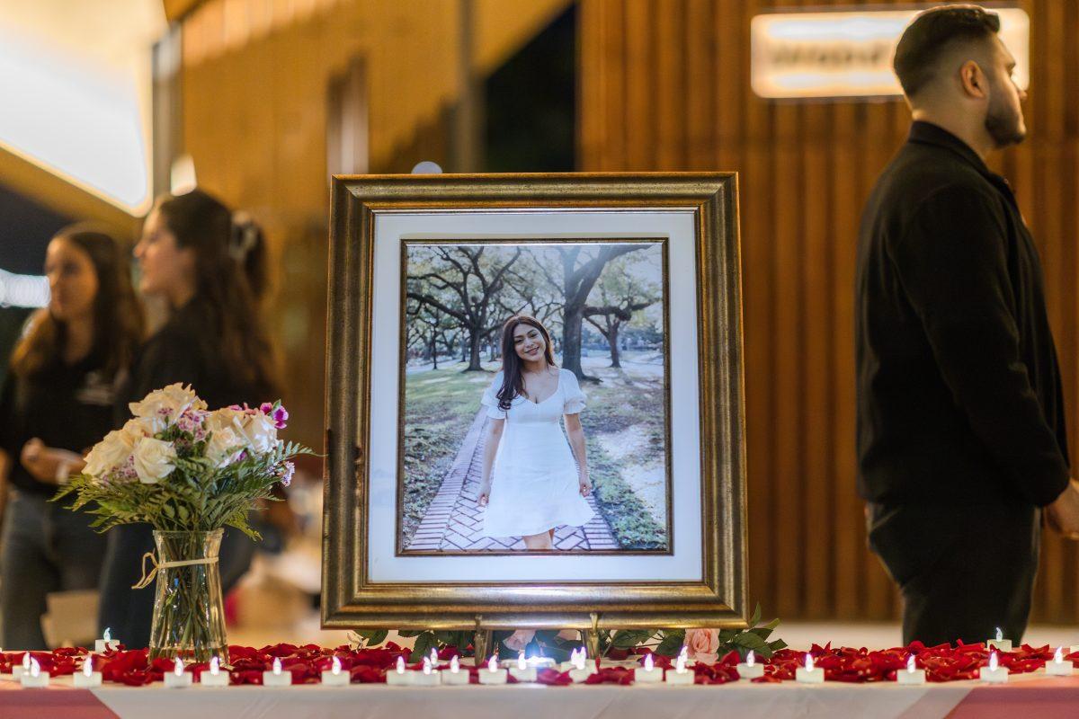 A stand with Britney Romero’s picture sits with candles on the Aggie Park Pavilion during her Balloon Memorial held by the Mexican Student Association on Thursday, Oct. 19, 2023. (Ishika Samant/The Battalion)
