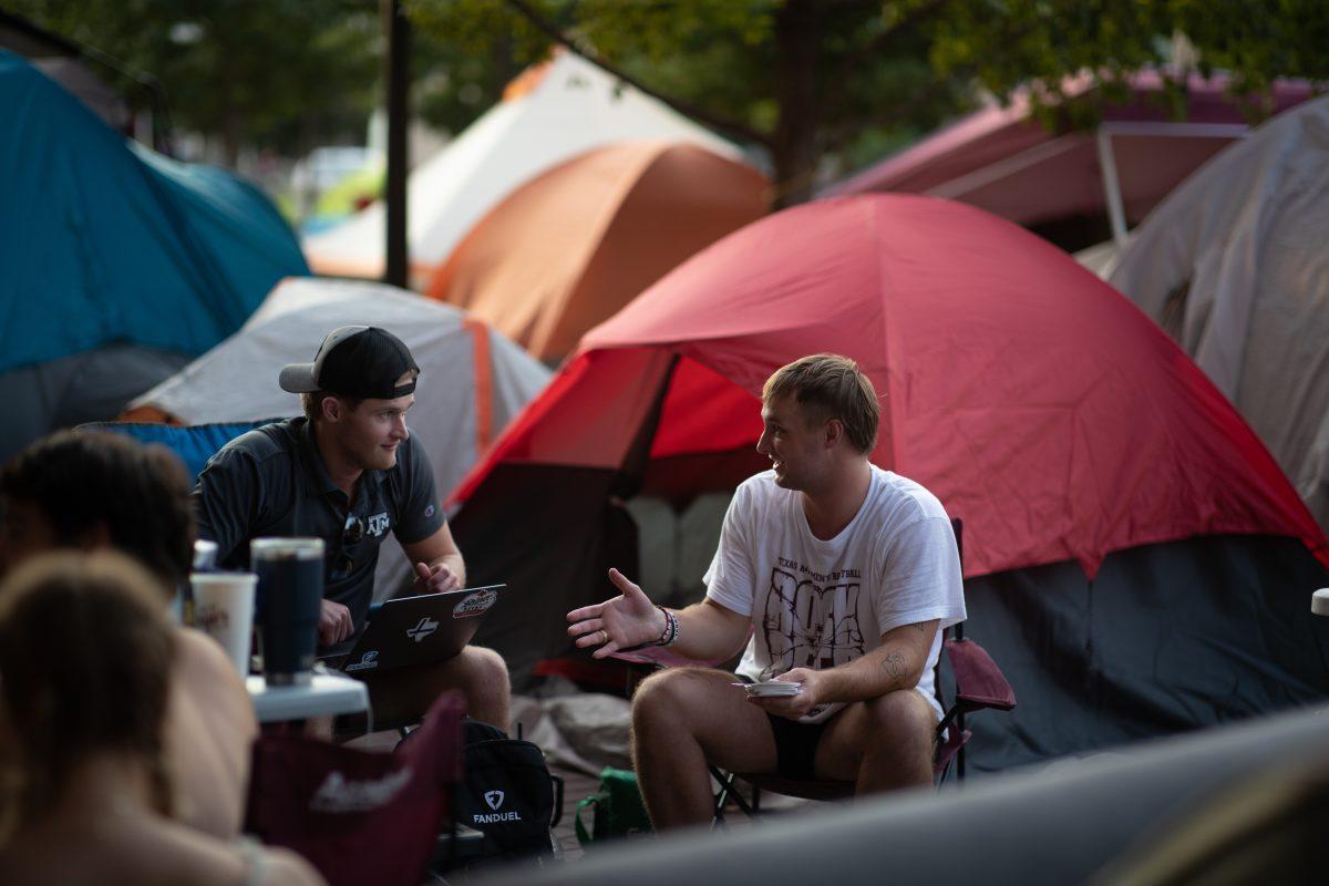 Poultry science senior Ryder Nielson and computer science senior Roope Raikaa talk in the ticket pull line outside Kyle Field on Sunday, Oct. 1, 2023.&#160;