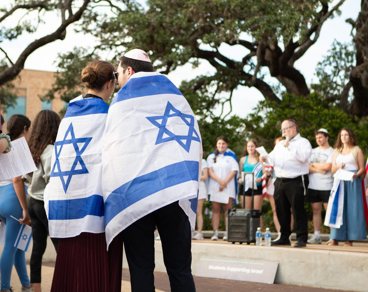 <p>Molecular and cell biology sophomore Alice Asinovsky and former student Ori Yonay stand in support of Israel during the Aggies Stand with Israel Silent Walk event on Thursday, Oct. 12, 2023.</p>