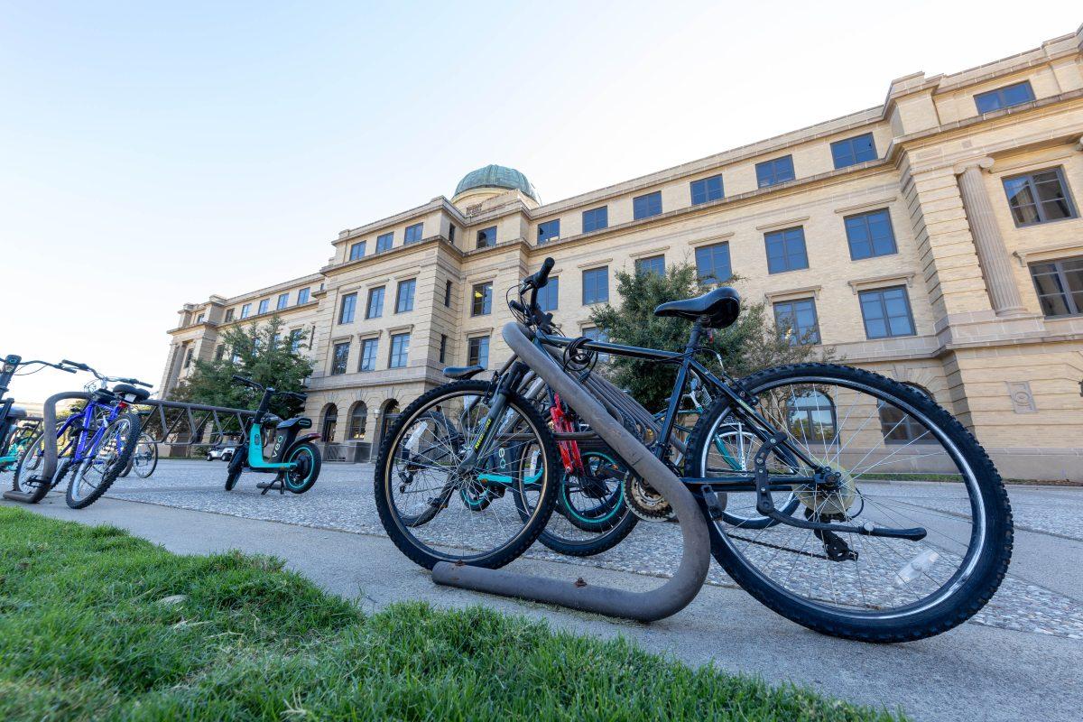 Bikes are stowed on racks in front of the Academic Building on Wednesday, Oct. 18, 2023. (Photo by Chris Swann/The Battalion)