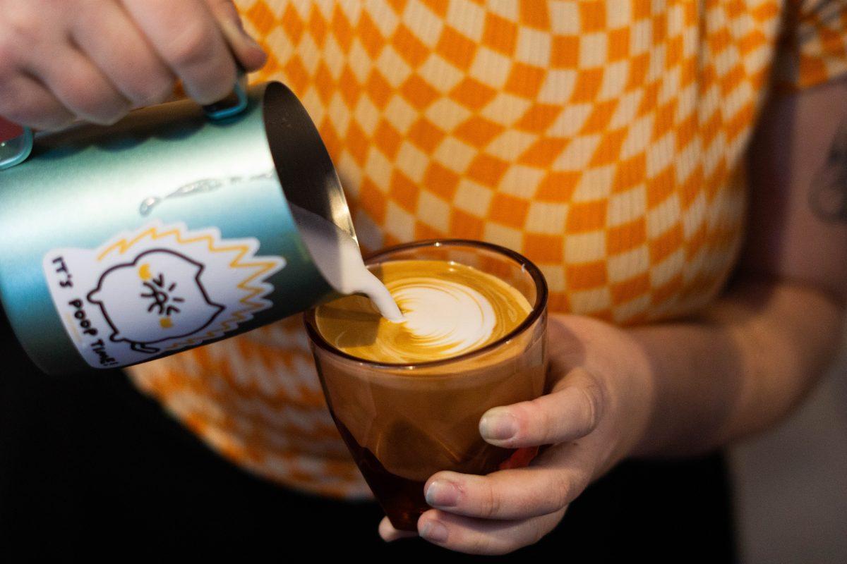 <p>Alicia Rutherford practices pouring before the latte art competition at Tavo Coffee Co. on Friday Oct. 6, 2023.</p>