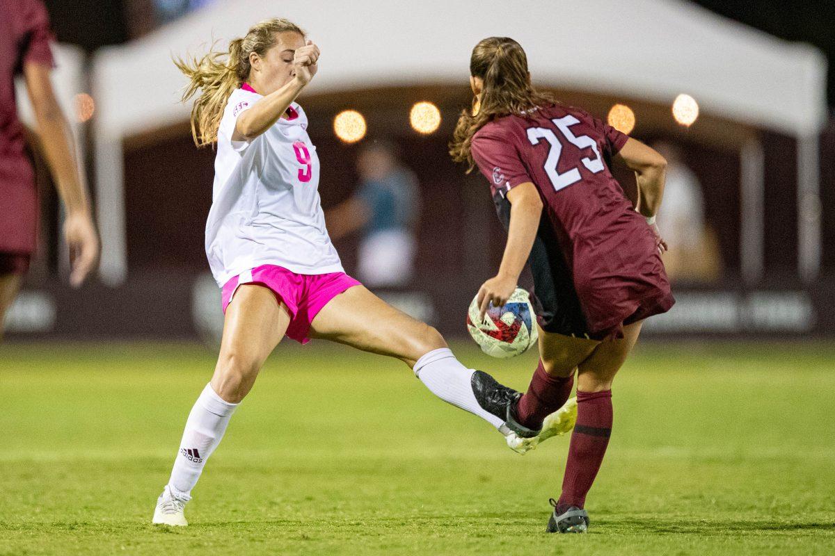 Senior M Taylor Pounds (9) fights for the ball between Gamecock defender Lily Render (25) during Texas A&Ms game vs. South Carolina at Ellis Field on Thursday, Oct. 19, 2023. (Chris Swann/The Battalion)