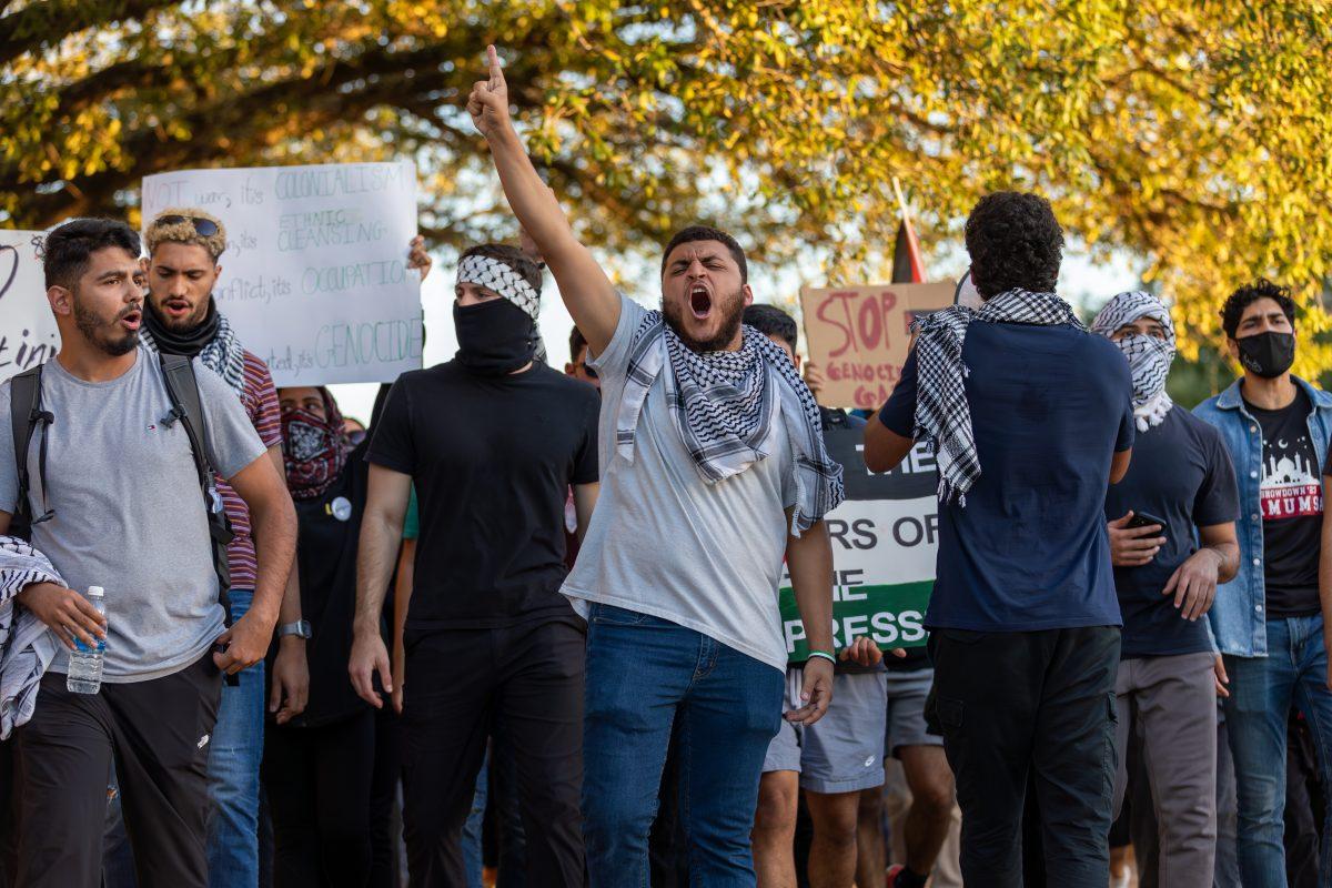 A marcher screams chants for Palestine while walking among his peers during the March For Palestine event on Thursday, Oct. 19, 2023. (CJ Smith/The Battalion)