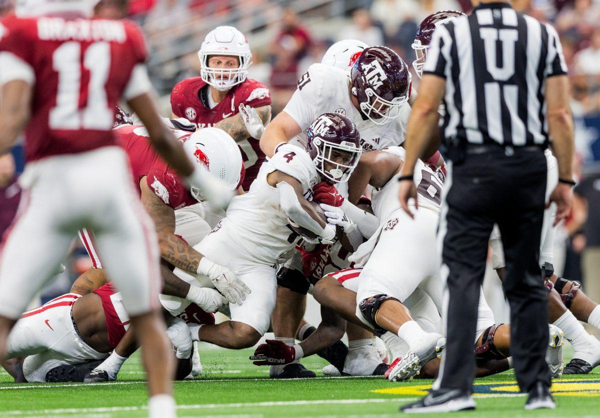 <p>Junior RB Amari Daniels (4) gets tackled during the Southwest Classic against Arkansas on Saturday, Sept. 30, 2023. (Ishika Samant/The Battalion)</p>