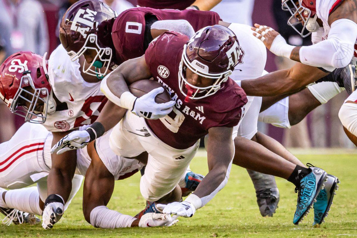 Sophomore RB Le'vion Moss (8) falls to the ground after a run during Texas A&amp;M's football game against Alabama at Kyle Field on Saturday, Oct. 7, 2023. (Chris Swann/The Battalion)