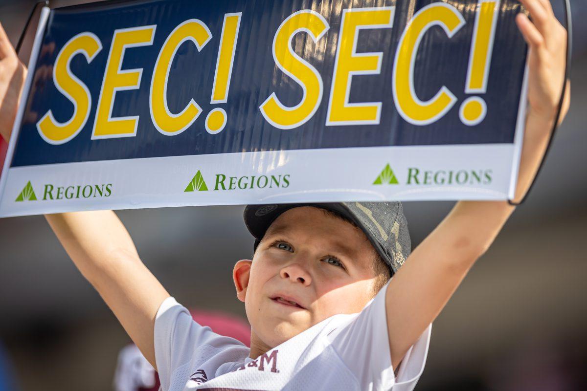 A young fan holds up an SEC sign before the start of Texas A&Ms football game against Auburn at Kyle Field on Saturday, Sept. 23, 2023.