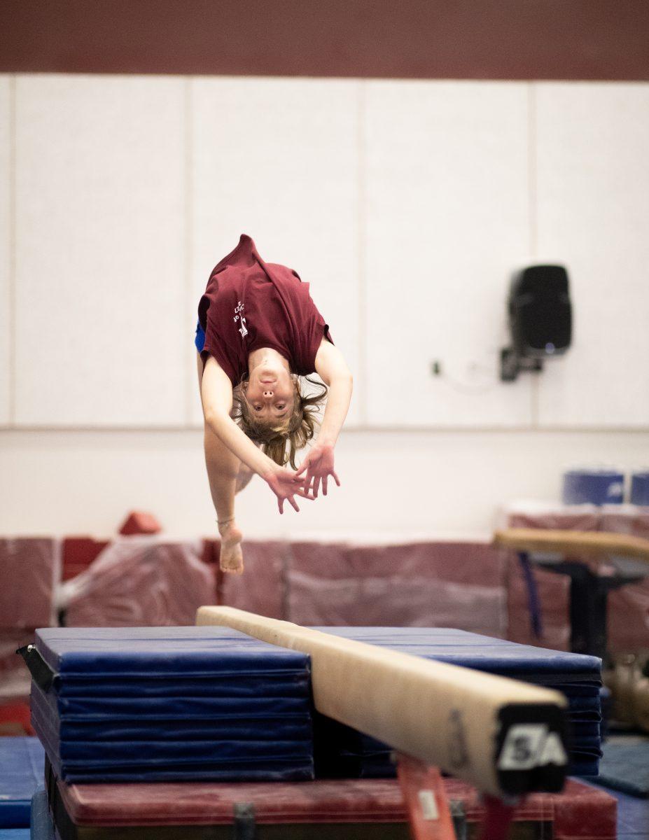 Biochemistry freshman Nico Weinhauer prepares her balance beam routine on Tuesday, Sept. 19, 2023.