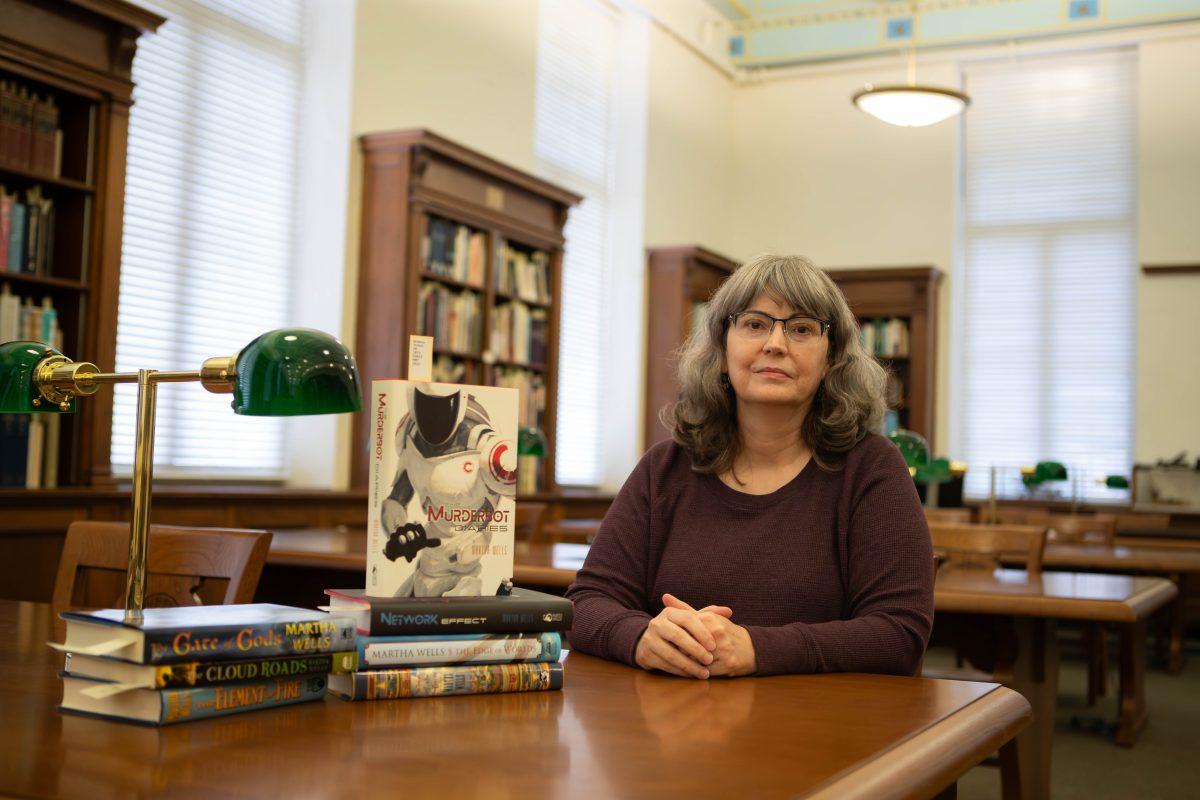 Author Martha Wells sits for a photo in the Cushing Memorial Library and Archives on Thursday, Nov. 2, 2023. (Connor May/The Battalion)