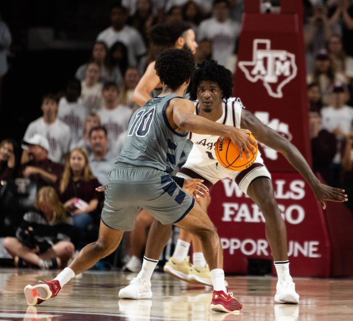 Sophomore F Solomon Washington (13) guards Oral Roberts G Issac McBride (10) during Texas A&Ms game against Oral Roberts in Reed Arena on Friday, Nov. 17, 2023.